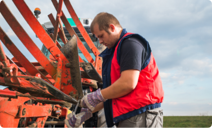 Man fixing farm machinery